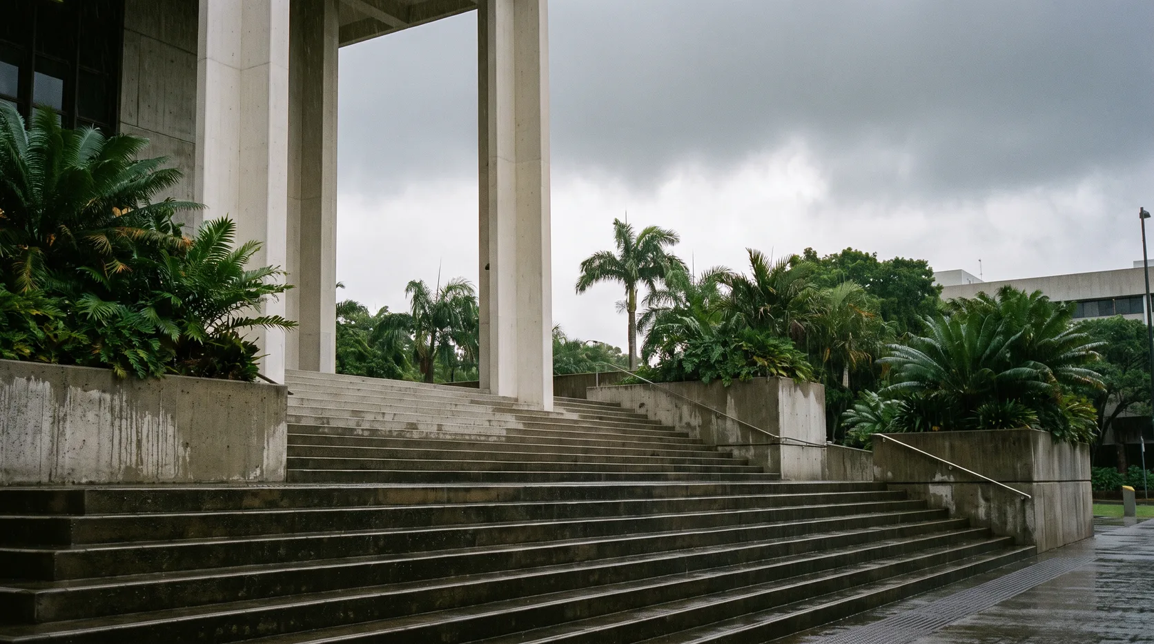 The empty steps and columns of a courthouse under an overcast sky